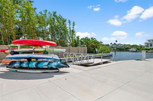 view of home's community featuring a dock and a water view