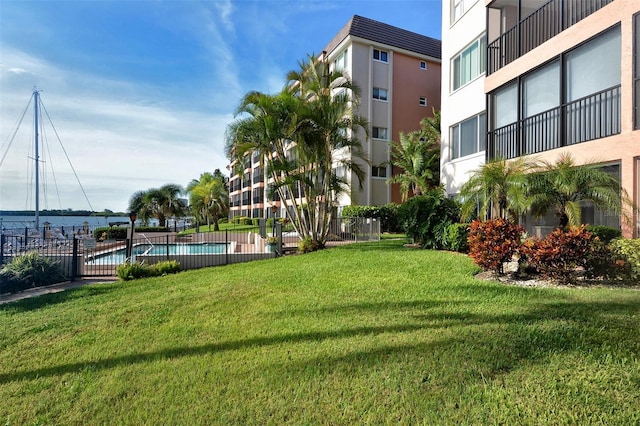 surrounding community featuring a pool and a yard