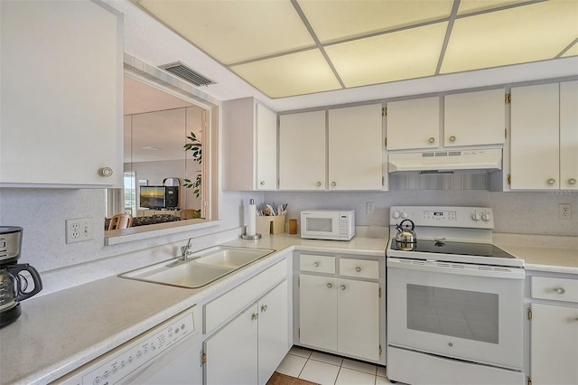 kitchen featuring light tile patterned flooring, sink, white cabinets, and white appliances