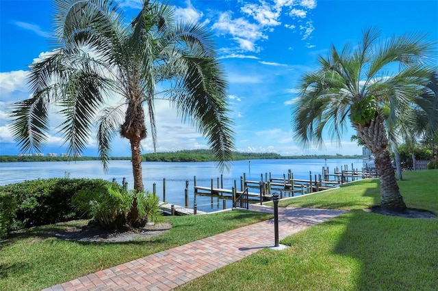 view of dock featuring a water view and a lawn