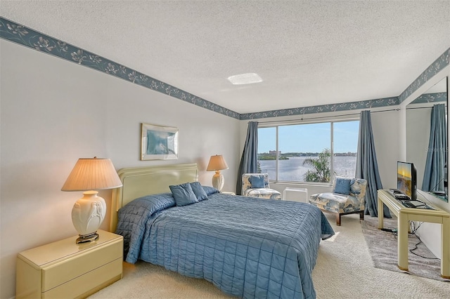 carpeted bedroom featuring a textured ceiling