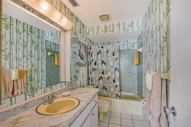 full bathroom featuring shower / tub combo, tile patterned flooring, vanity, a textured ceiling, and toilet