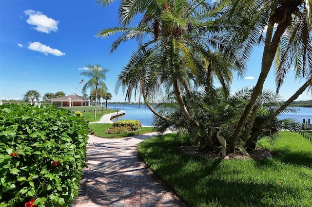 view of home's community featuring a water view and a yard