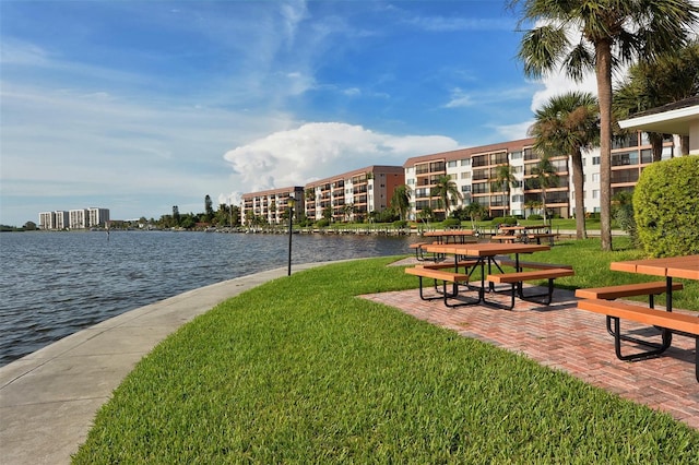 view of property's community featuring a yard and a water view