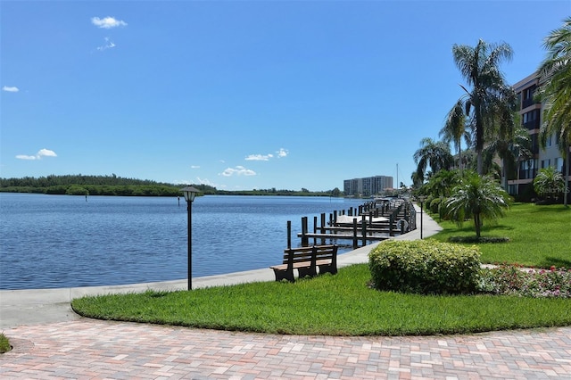 view of dock featuring a water view and a lawn