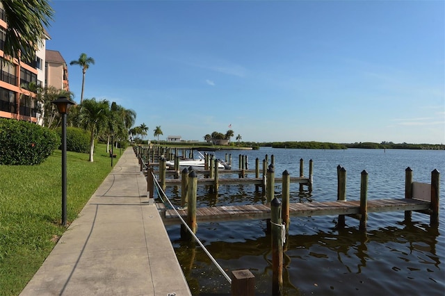 view of dock featuring a yard and a water view