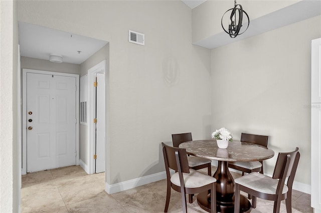 dining area with an inviting chandelier