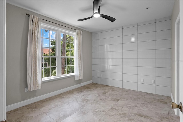 unfurnished room with ceiling fan