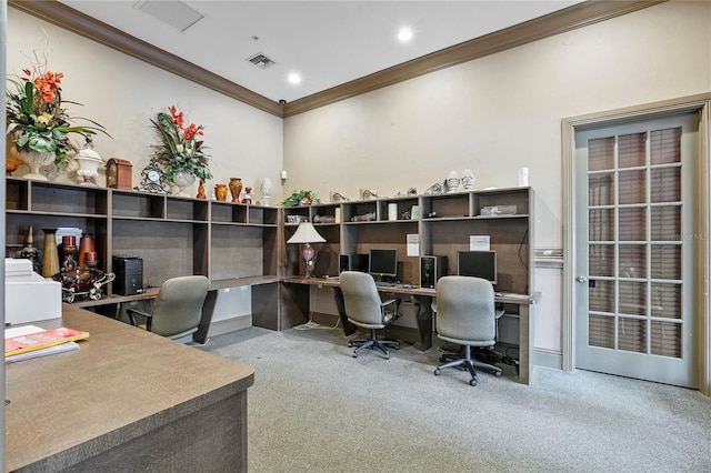 carpeted office featuring ornamental molding and built in desk