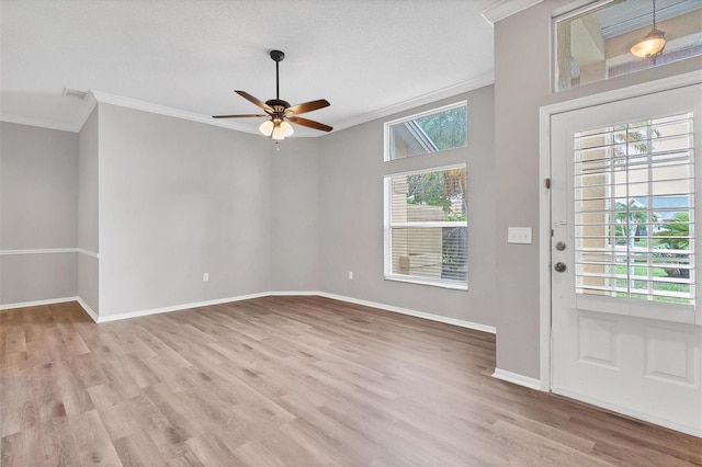 entryway with a textured ceiling, light hardwood / wood-style floors, ceiling fan, and crown molding