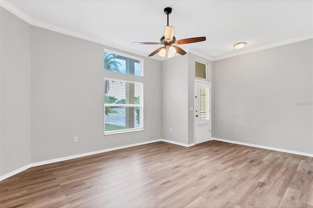 empty room with ceiling fan, light hardwood / wood-style flooring, and ornamental molding