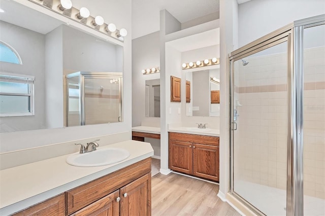 bathroom featuring vanity, wood-type flooring, and an enclosed shower