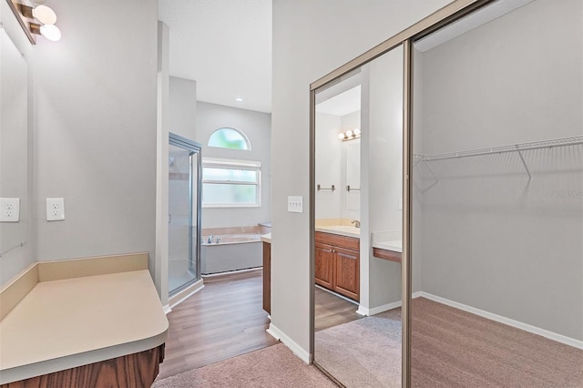 bathroom with vanity and a shower with door