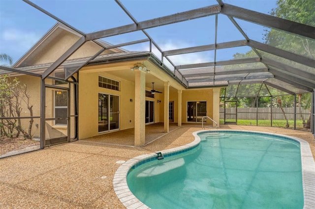 view of swimming pool featuring a patio, ceiling fan, and a lanai