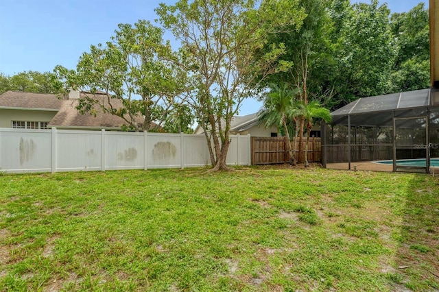 view of yard with a fenced in pool and a lanai