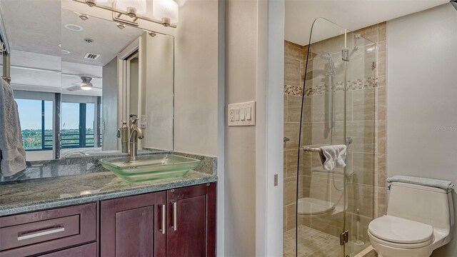 bathroom featuring vanity, toilet, and walk in shower