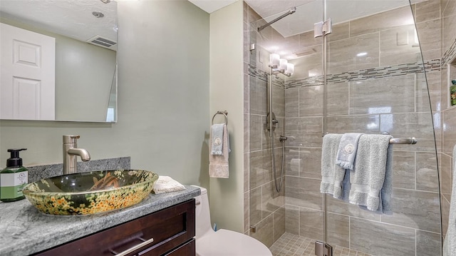 bathroom featuring vanity, toilet, and an enclosed shower