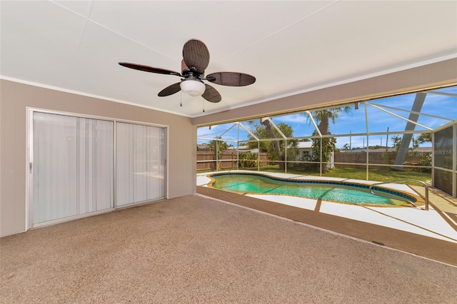 view of pool with a lanai, ceiling fan, and a patio area