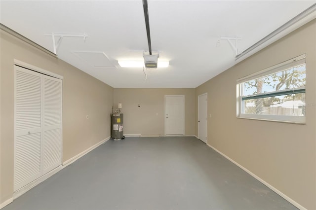 garage featuring water heater and a garage door opener