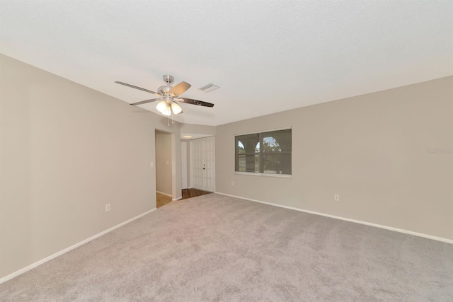 carpeted empty room featuring a textured ceiling and ceiling fan