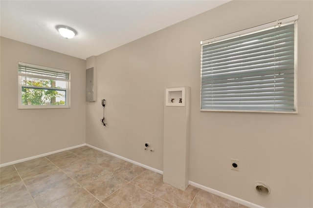 clothes washing area featuring electric panel, hookup for a gas dryer, hookup for a washing machine, and hookup for an electric dryer