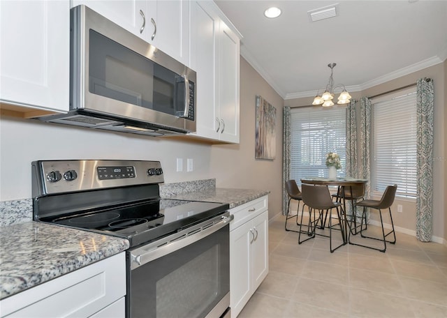 kitchen with light stone counters, crown molding, light tile patterned floors, appliances with stainless steel finishes, and white cabinets