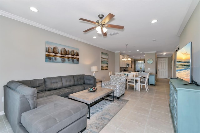 living room with crown molding, ceiling fan, and light tile patterned floors