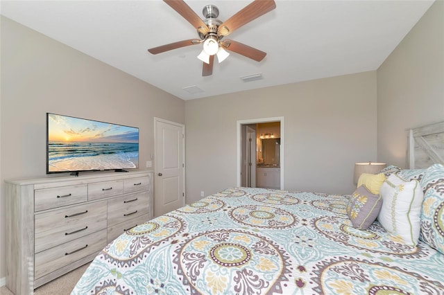 carpeted bedroom featuring ceiling fan and ensuite bathroom