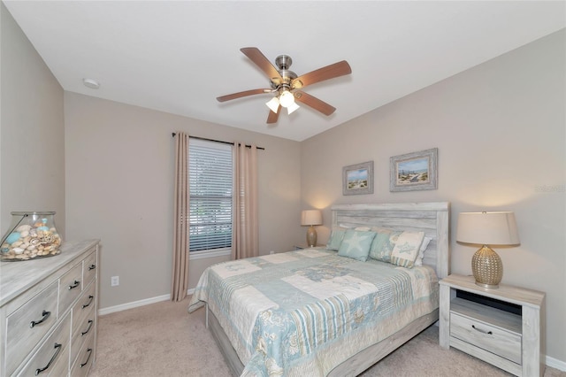 bedroom featuring light carpet and ceiling fan