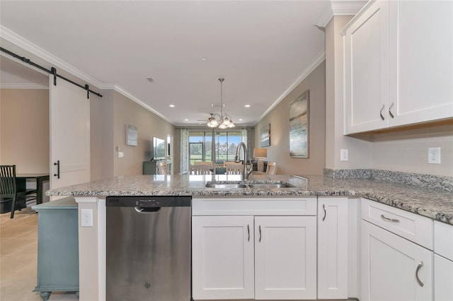 kitchen featuring sink, dishwasher, white cabinetry, a barn door, and kitchen peninsula