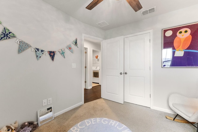 bedroom featuring carpet flooring, ceiling fan, and washer / dryer