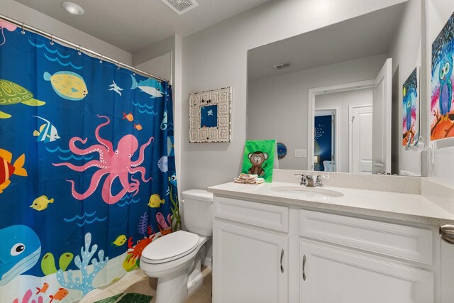 bathroom with tile patterned floors, vanity, and toilet