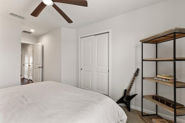 carpeted bedroom featuring ceiling fan and a closet