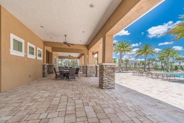 view of patio / terrace with ceiling fan and a community pool