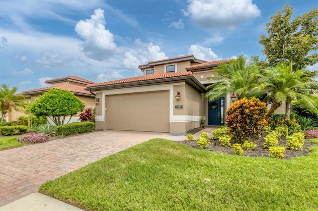 mediterranean / spanish house with a garage and a front yard