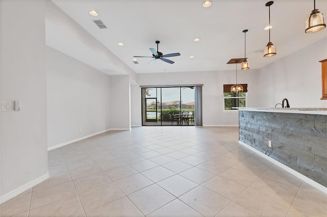 unfurnished living room with ceiling fan and light tile patterned flooring