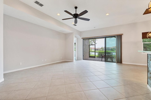 tiled empty room featuring ceiling fan