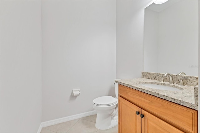 bathroom featuring toilet, vanity, and tile patterned flooring