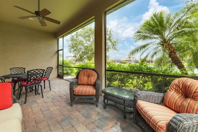 sunroom / solarium featuring ceiling fan