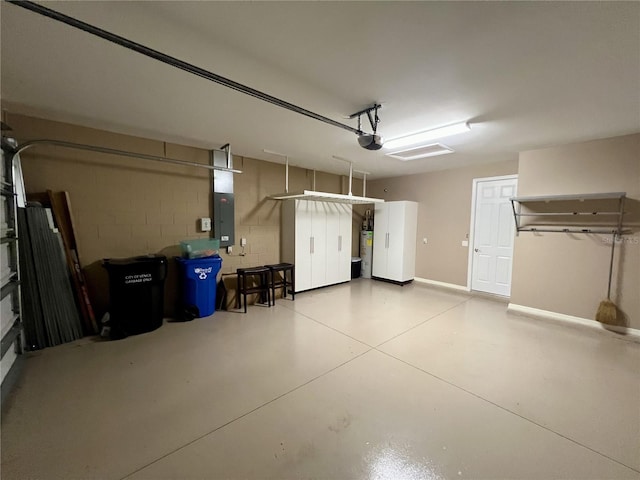 garage featuring electric water heater and electric panel