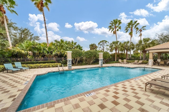 view of pool featuring pool water feature and a patio area