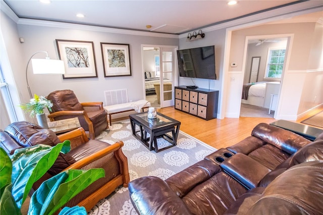 living room featuring light wood-type flooring and ornamental molding