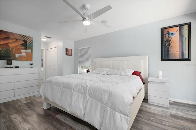 bedroom with ceiling fan, a closet, and hardwood / wood-style floors