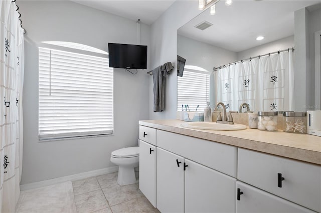 bathroom with toilet, tile patterned flooring, and vanity