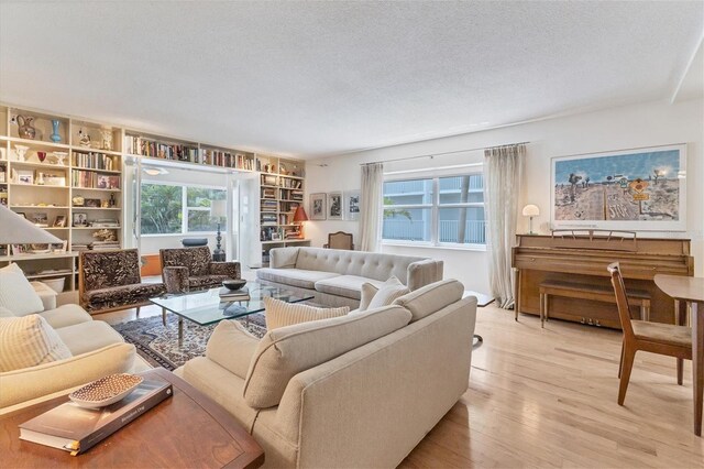 living room with hardwood / wood-style floors and a textured ceiling