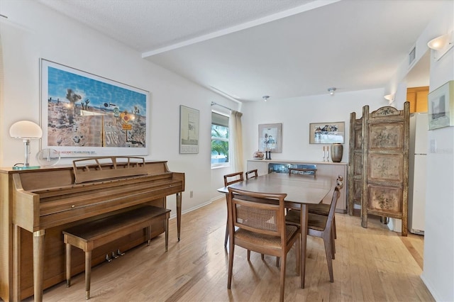 dining area with light hardwood / wood-style floors