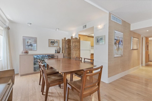 dining area featuring light wood-type flooring