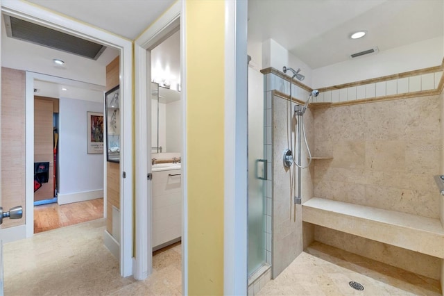 bathroom featuring a shower with door