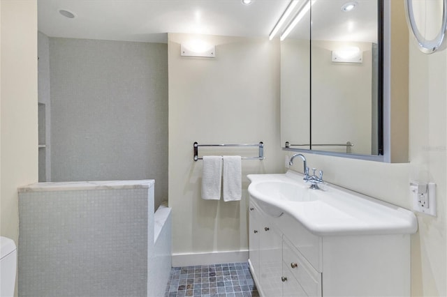 bathroom featuring vanity, tile patterned floors, and toilet