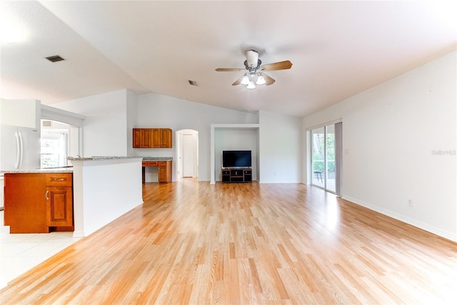 unfurnished living room with ceiling fan, light hardwood / wood-style floors, and lofted ceiling